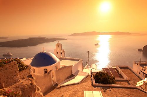 Santorini with sunset over Church in Fira town, Greece © Shutterstock