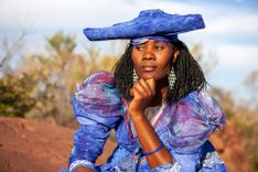 Herero woman wearing a Victorian style dress outdoors in a village in north Botswana © Lucian Coman/Shutterstock