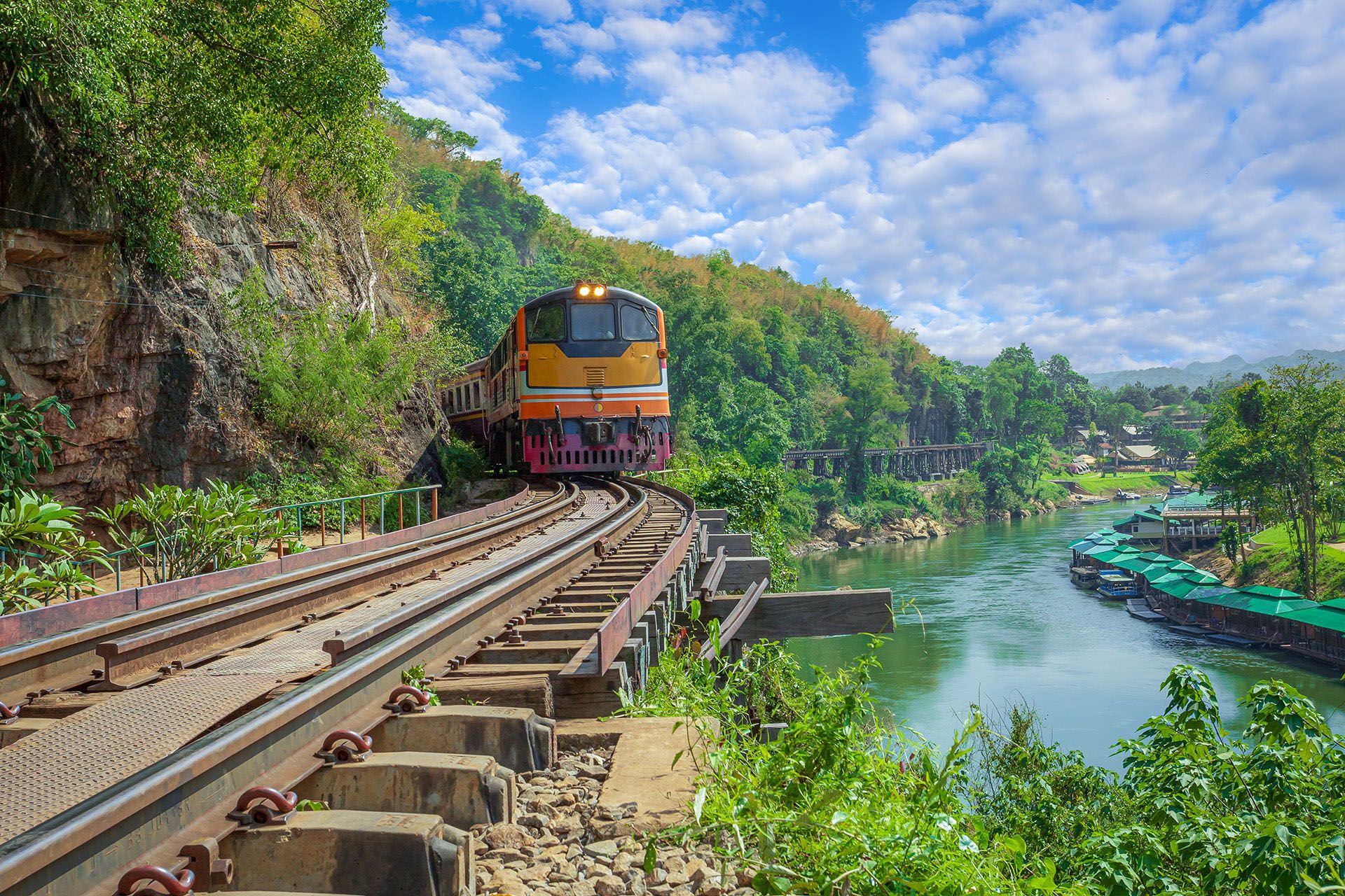 trains running on death railways track crossing kwai river in kanchanaburi thailand this railways important destination of world war II history builted by soldier prisoners © banjongseal324/Shutterstock